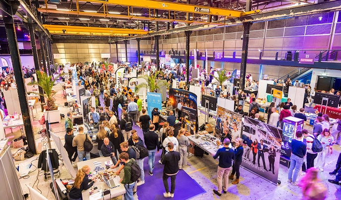 Birdseye view van het Fontys Career Event met studenten en standhouders in gesprek.